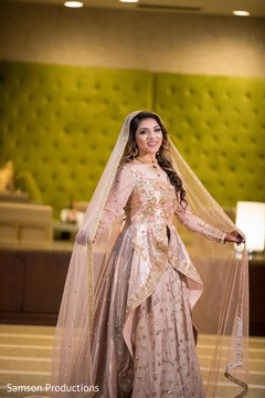 Indian bride showing off her pale pink attire Indian bride showing off her pale pink attire