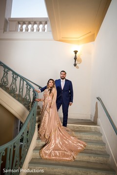 Indian newlywed couple standing on the stairs Indian newlywed couple standing on the stairs