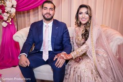 Indian newlyweds sitting on the pink stage Indian newlyweds sitting on the pink stage