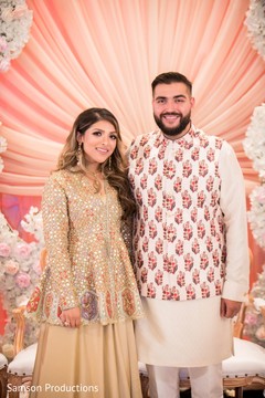 Indian groom and his Maharani with a decorated background Indian groom and his Maharani with a decorated background