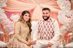 Maharani and her Indian groom sitting on a decorated stage Maharani and her Indian groom sitting on a decorated stage
