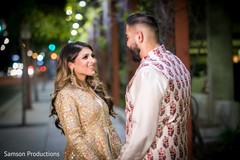 Indian couple looking into each other eyes on an illuminated street Indian couple looking into each other eyes on an illuminated street