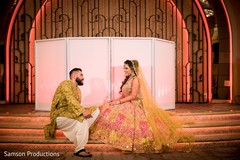 Indian couple sitting on the stage steps Indian couple sitting on the stage steps