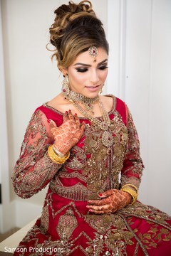Maharani in red and gold showing her henna stained hands Maharani in red and gold showing her henna stained hands