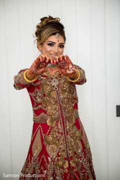 Indian bride making a heart shape with her henna stained hands Indian bride making a heart shape with her henna stained hands