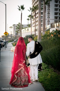 Indian newlyweds walking together on the sidewalk Indian newlyweds walking together on the sidewalk