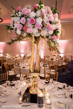A tall flower jar on the center of one of the tables A tall flower jar on the center of one of the tables