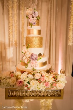 The wedding cake decorated with flowers and gold The wedding cake decorated with flowers and gold