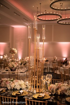 A tall candle decoration on one of the tables A tall candle decoration on one of the tables