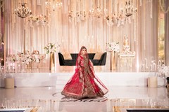Maharani in red and gold in front of the reception stage Maharani in red and gold in front of the reception stage