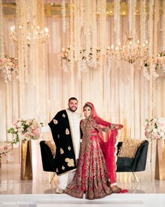 Indian newlyweds with open arms at the reception venue Indian newlyweds with open arms at the reception venue