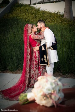 Indian newlyweds kissing outside the wedding venue Indian newlyweds kissing outside the wedding venue
