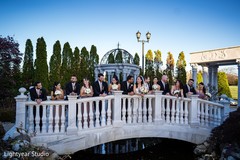 Large Indian wedding party posing over a bridge. Large Indian wedding party posing over a bridge.