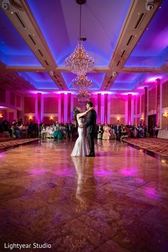 Indian couple dancing in front of family and friends. Indian couple dancing in front of family and friends.