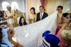 Indian couple traditional first look under the mandap. Indian couple traditional first look under the mandap.