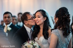 Indian bride being kissed by parents. Indian bride being kissed by parents.