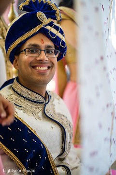 Indian groom wearing his blue turban and white blue sherwani. Indian groom wearing his blue turban and white blue sherwani.
