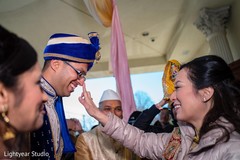 Indian groom on his blue turban during his milni celebration. Indian groom on his blue turban during his milni celebration.