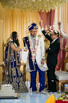 Indian couple being thrown rose petals at ceremony. Indian couple being thrown rose petals at ceremony.