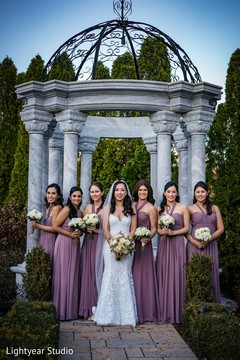 Indian bride with bridesmaids holding their ceremony bouquets. Indian bride with bridesmaids holding their ceremony bouquets.