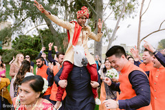 Indian groom riding a man with a white horse mask Indian groom riding a man with a white horse mask