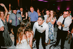Indian couple dancing in surrounded by their guests. Indian couple dancing in surrounded by their guests.