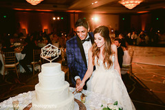Indian couple cutting the wedding cake. Indian couple cutting the wedding cake.