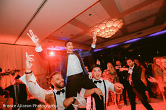 Indian groom on lifted by his groomsmen. Indian groom on lifted by his groomsmen.