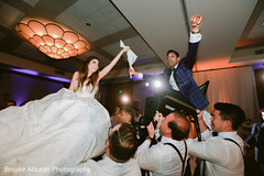 Indian bride and Indian groom being lifted by the groomsmen. Indian bride and Indian groom being lifted by the groomsmen.