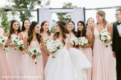 Maharani and her bridesmaids holding white rose bouquets. Maharani and her bridesmaids holding white rose bouquets.