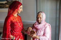 Indian bride getting on her kalire from relative. Indian bride getting on her kalire from relative.