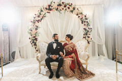 Indian bride and groom on their red and golden saree and black suit. Indian bride and groom on their red and golden saree and black suit.