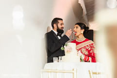 Lovely capture Indian bride and groom cutting cake together. Lovely capture Indian bride and groom cutting cake together.