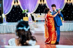 Indian groom dancing with mother at reception capture. Indian groom dancing with mother at reception capture.