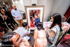 Indian wedding guests signing guest photo frame. Indian wedding guests signing guest photo frame.