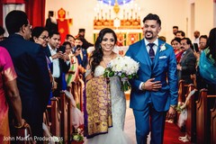 Indian couple walking down the aisle out of wedding ceremony. Indian couple walking down the aisle out of wedding ceremony.