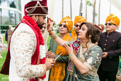 Indian groom getting the red mark on forehead at milni. Indian groom getting the red mark on forehead at milni.
