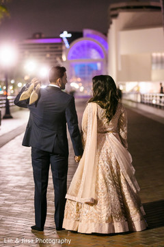 Indian groom and Indian bride walking together with streetlights. Indian groom and Indian bride walking together with streetlights.