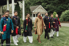 Indian groom with groomsmen walking on their sangeet outfits. Indian groom with groomsmen walking on their sangeet outfits.