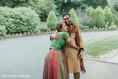 Indian couple posing outdoors on Sangeet outfits. Indian couple posing outdoors on Sangeet outfits.