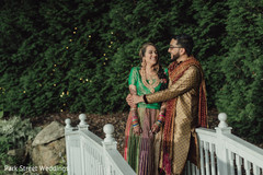 Indian couple posing on a white bridge capture. Indian couple posing on a white bridge capture.
