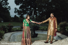 Indian bride and groom posing in front of a fountain. Indian bride and groom posing in front of a fountain.
