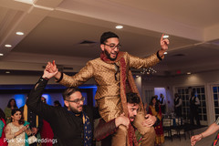 Indian groom lifted by groomsmen at Sangeet dance. Indian groom lifted by groomsmen at Sangeet dance.