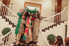 Indian bride walking down the stairs on her sangeet outfit. Indian bride walking down the stairs on her sangeet outfit.