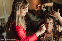 Indian bride getting her wedding ceremony makeup and hair done. Indian bride getting her wedding ceremony makeup and hair done.