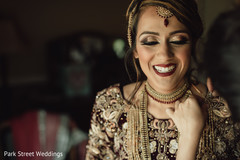Indian bride getting her golden necklace on. Indian bride getting her golden necklace on.