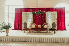 Red draping with white flowers for indian wedding stage decor. Red draping with white flowers for indian wedding stage decor.