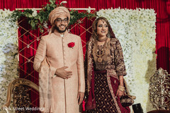 Indian bride and groom posing at their ceremony stage. Indian bride and groom posing at their ceremony stage.