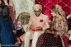 Indian groom getting the wedding rings of the pillow. Indian groom getting the wedding rings of the pillow.