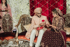 Indian groom putting wedding ring to bride. Indian groom putting wedding ring to bride.